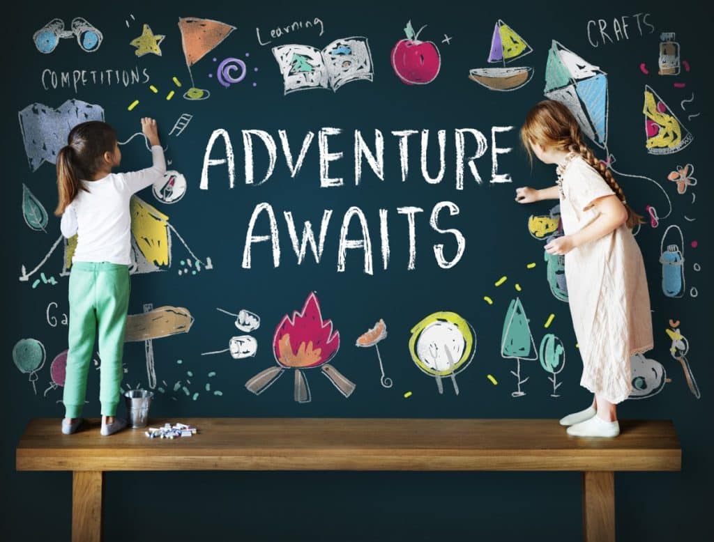 Kids drawing on a chalkboard