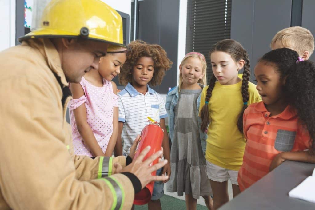 Firefighter teaching safety to kids