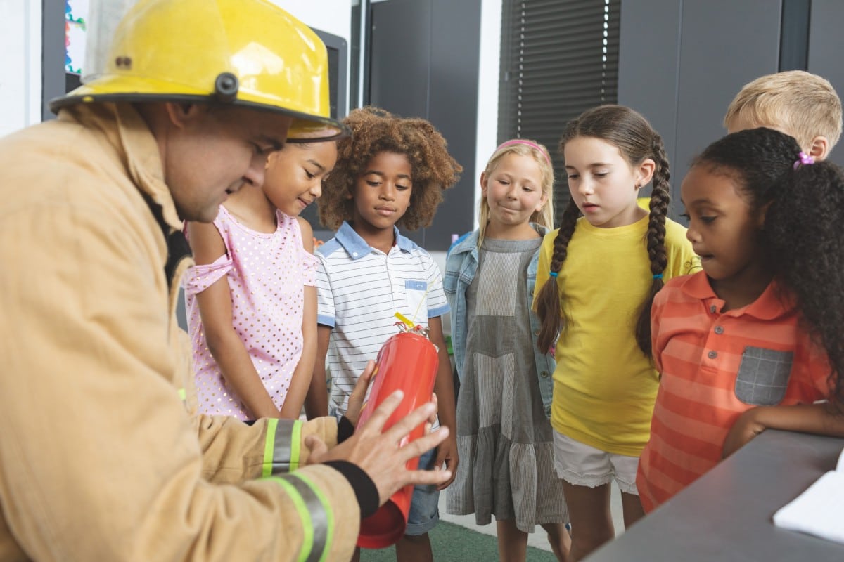 Firefighter teaching safety to kids