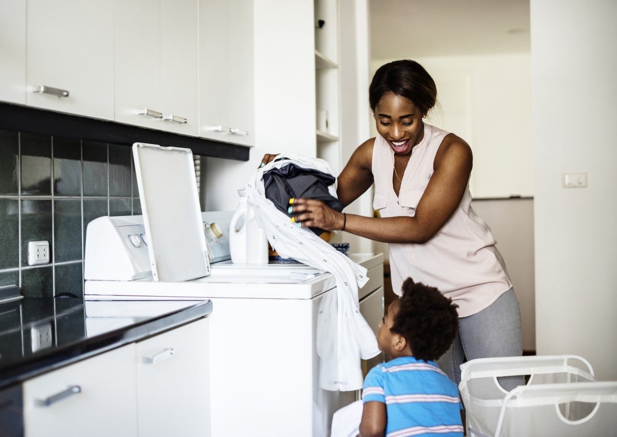 parent and child doing laundry together